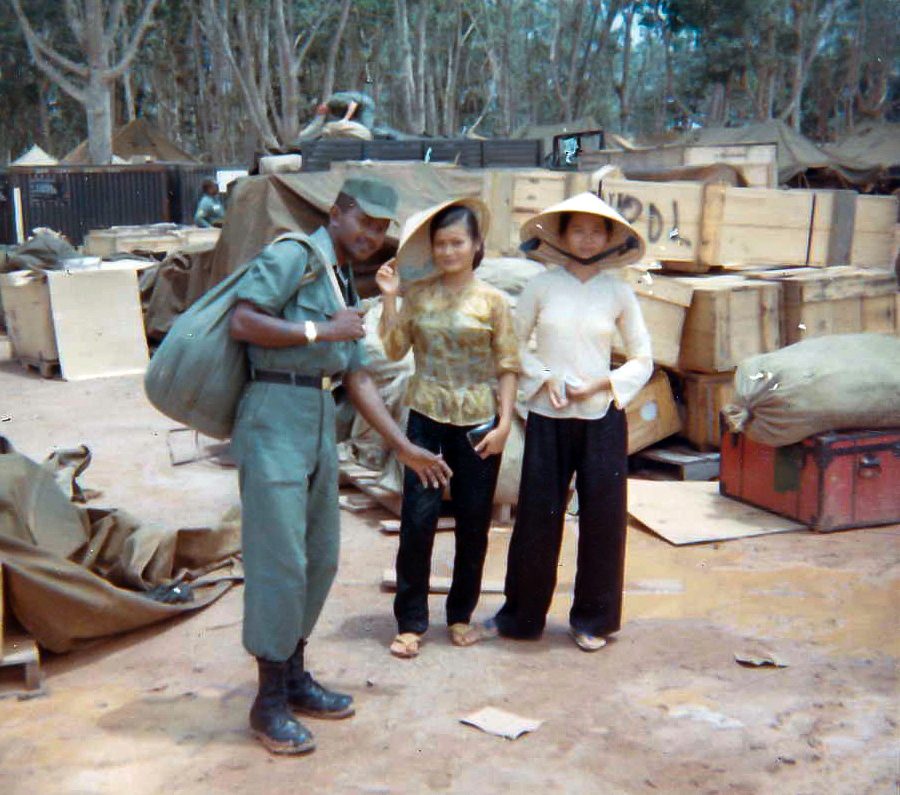 Unknown 506th S&S Co EM with civilians, Long Binh - Aug 1966