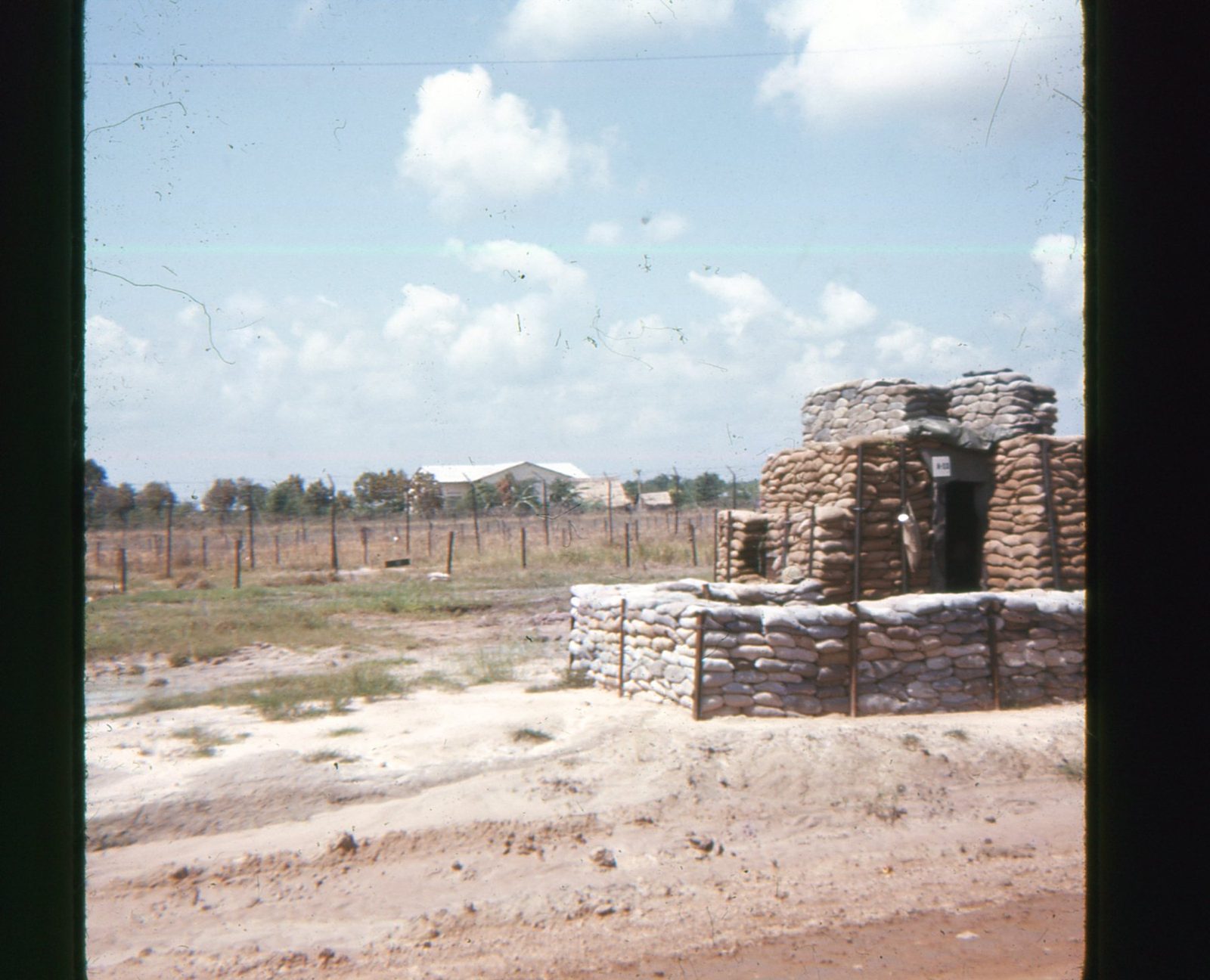 Bunker and barbed wire on perimeter, Cu Chi 1966